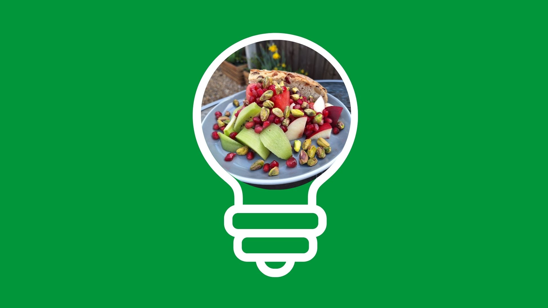 Light bulb icon on green background showing plate of fruit